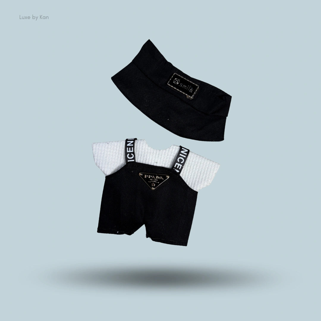 Labubu doll baddie streetwear outfit: black visor, white shirt, and black overall shorts with "NICE" straps and Prada logo.