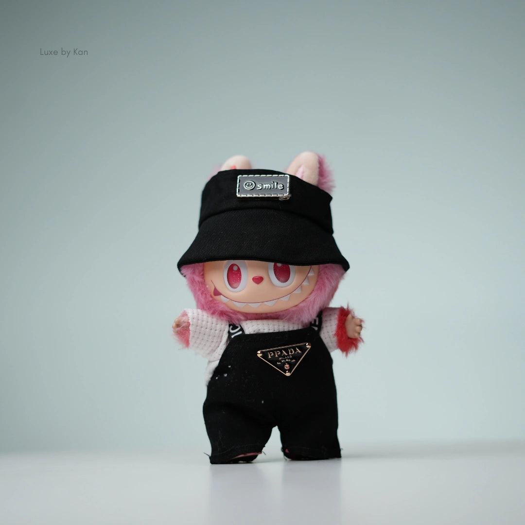 Pink Labubu doll in black Prada overalls and black bucket hat.