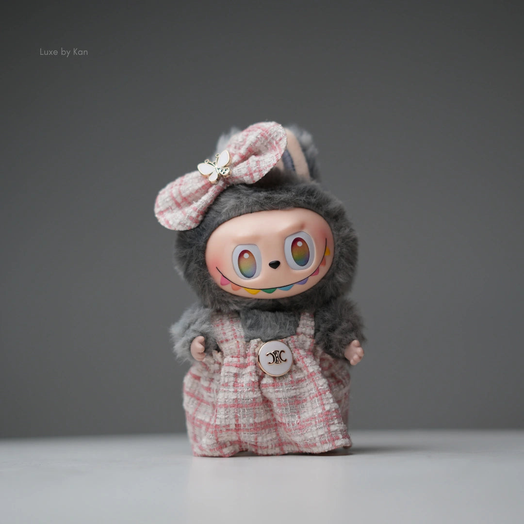 Pop Mart Labubu doll with gray fur and pink tweed dress and bow.