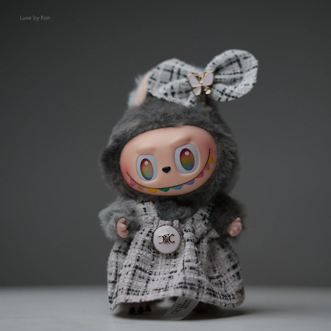 Pop Mart Labubu doll, gray flocked body with tweed dress outfit, bow, and rainbow smile.
