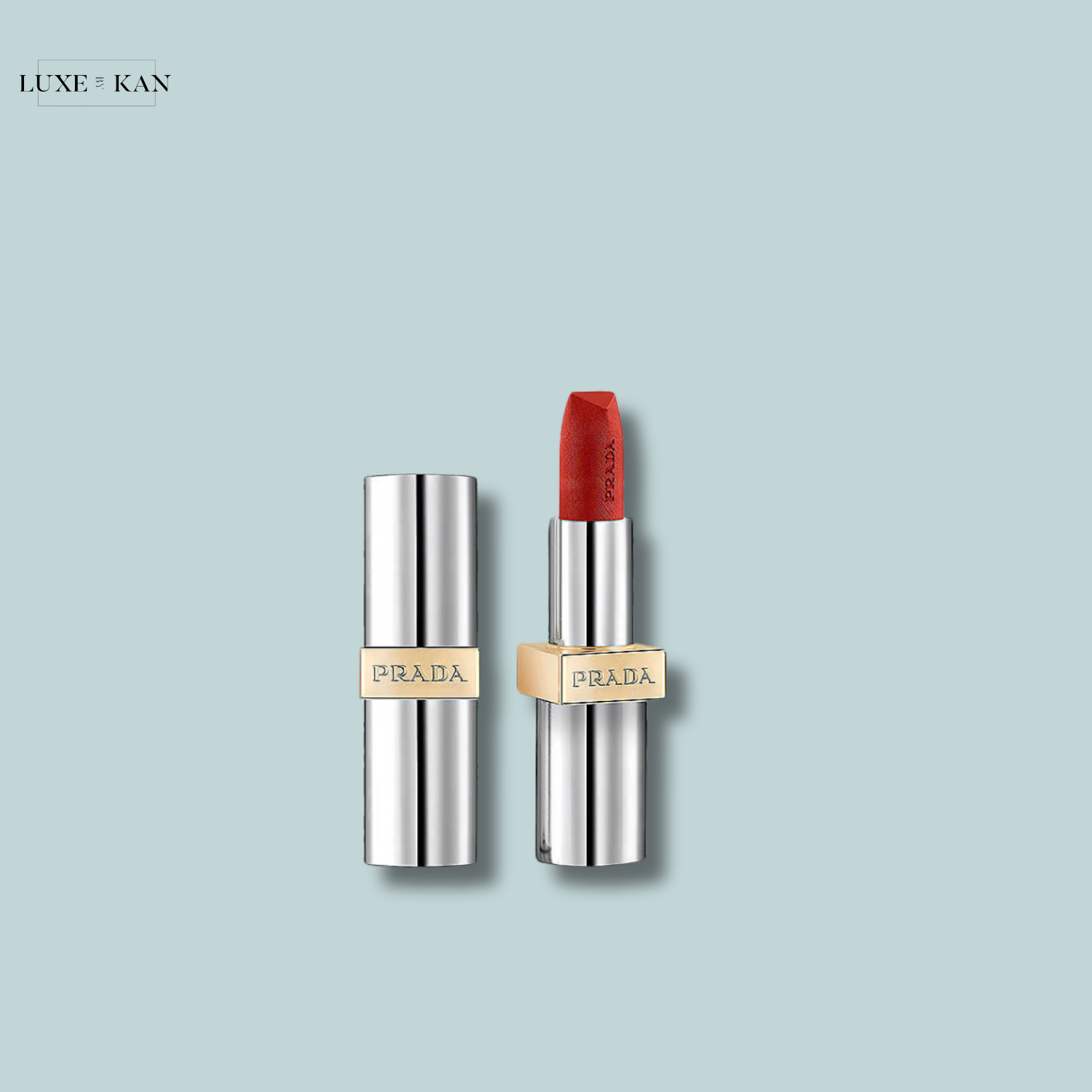 Close-up of a luxurious Prada lipstick in a sleek silver tube, featuring a bold red shade.