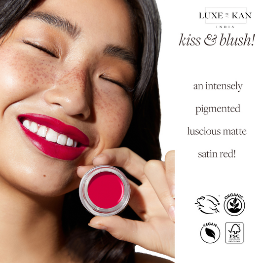 A hand holding a jar of laali lip paint pot, promoting vegan and organic beauty products.