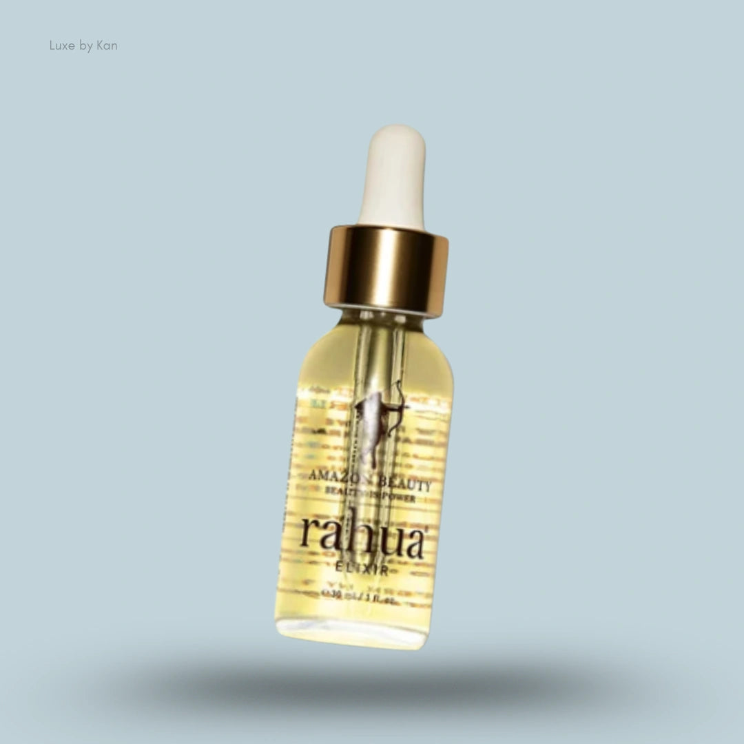 Rahua elixir oil in a clear glass bottle with a gold cap and white dropper.