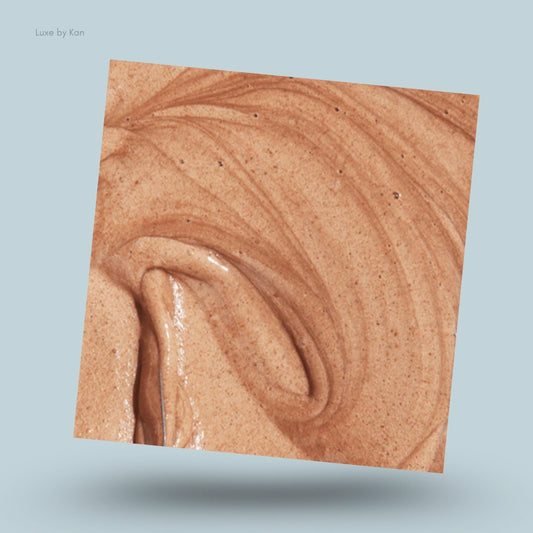 Close-up of Rahua scalp exfoliating shampoo featuring a swirling, light brown, textured mixture.