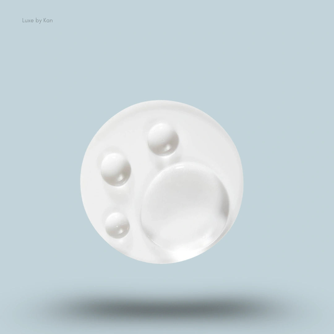 Close up view of translucent Ranavat regenerative conditioner on a round surface.