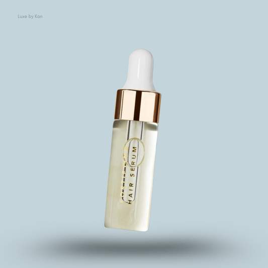 Ranavat hair serum bottle with a white cap, gold rim, and serum in clear bottle.