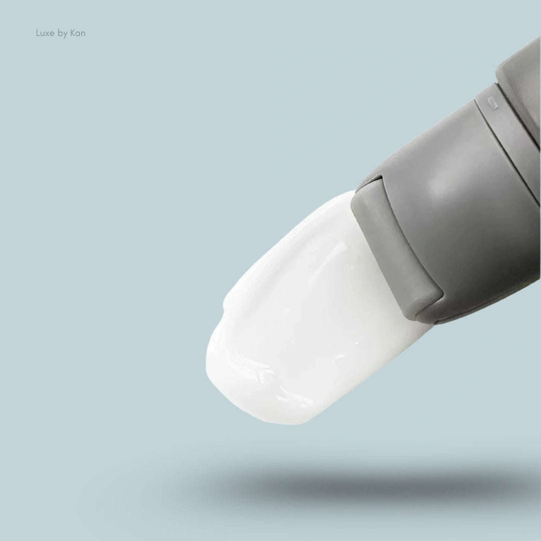 Close-up of Refy face primer applicator head with white primer being dispensed.