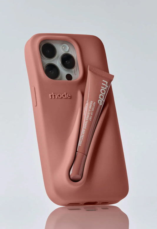 Rhode phone case in a toast color with a Rhode Peptide Lip Treatment inside.