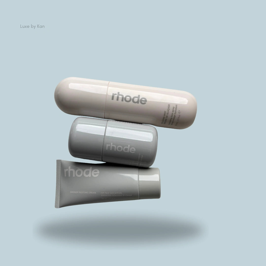 Rhode Skincare Glow Set features a mist spray, a serum, and a cream stacked against a light blue background.