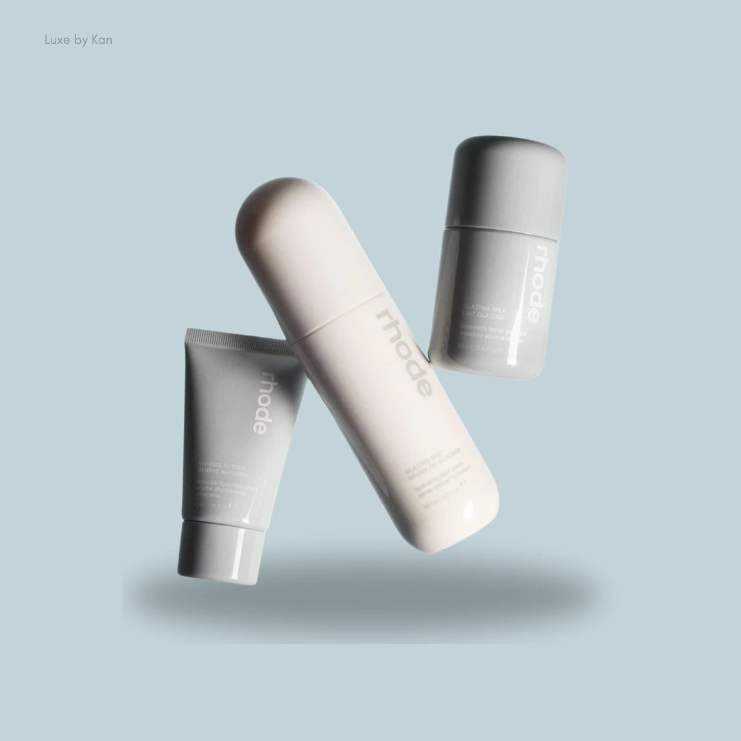 Three sleek skincare essentials from Rhode The Glow Set: Glazing Mist, Glazing Milk, and Barrier Butter, showcasing a modern, minimalist design.