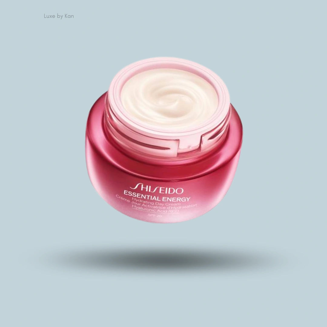 Shiseido Essential Energy Hydrating Day Cream SPF 20 jar. Full jar of light cream, pink jar, floating on light blue background.