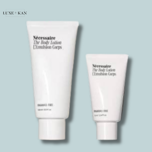 Two white tubes of Necessaire body lotion, one larger and one smaller, against a soft blue background, labeled "fragrance-free."