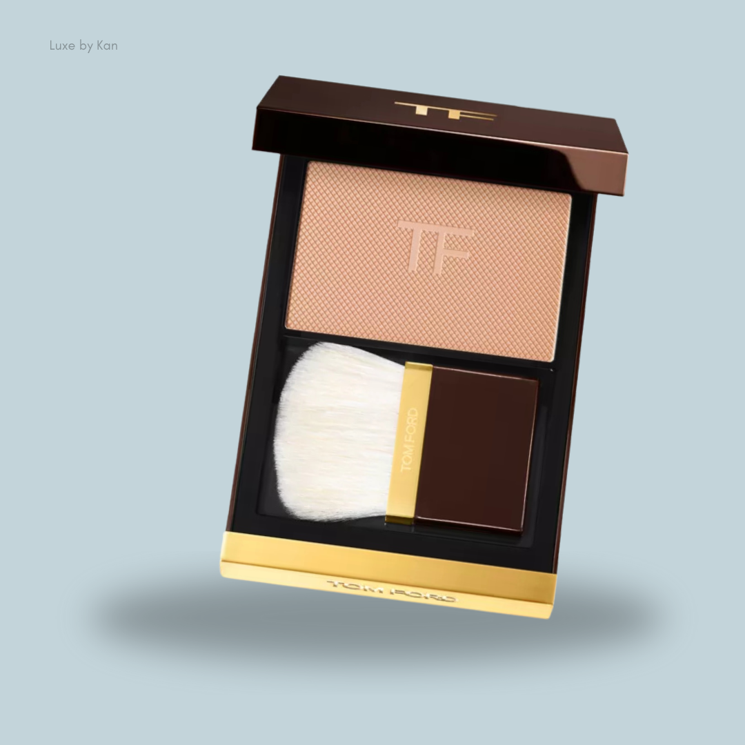 Tom Ford beauty compact featuring a textured powder with TF logo and a soft brush.