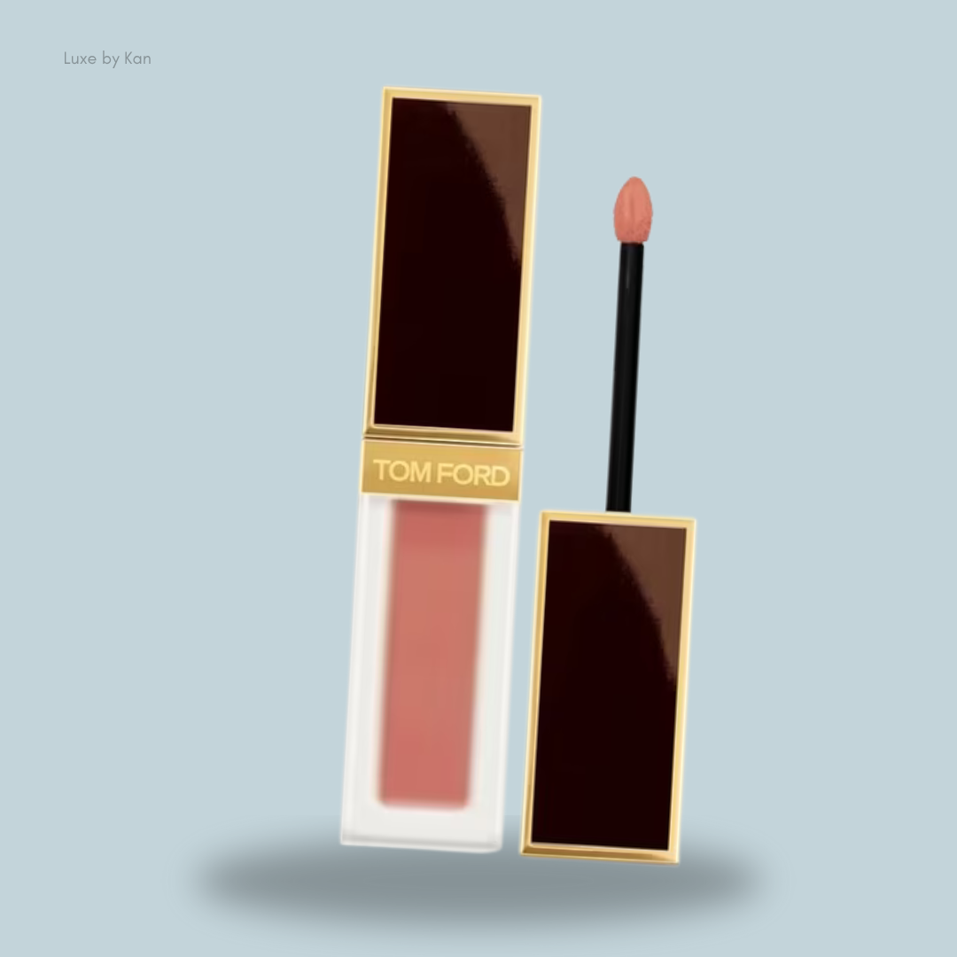 A sleek Tom Ford liquid lipstick with a nude pink shade, featuring a black applicator and elegant gold accents.