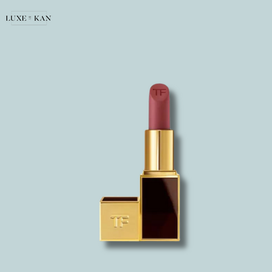A luxurious Tom Ford Matte Lip Colour lipstick in a gold and black case, featuring a soft mauve shade with "TF" embossed on the bullet.