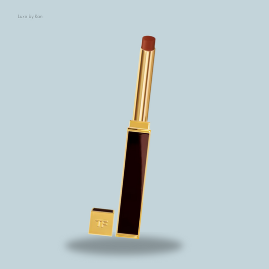 Tom Ford Slim Lip Color Shine lipstick tube in gold and burgundy, featuring a smooth brown bullet.