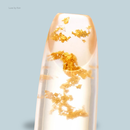 Close-up of a Tom Ford Soleil Lip Blush featuring scattered gold flakes, showcasing an elegant and luxurious design.