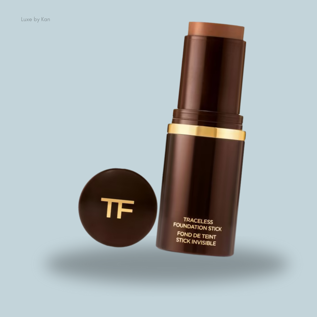 Tom Ford Traceless Foundation Stick in a sleek brown tube, displayed upright with cap beside it.