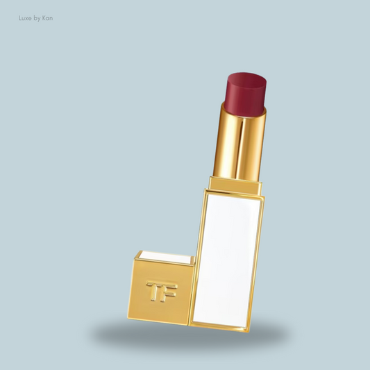 Tom Ford Ultra Shine Lip Colour lipstick tube with a deep burgundy bullet, featuring the "TF" branding visible on the base.