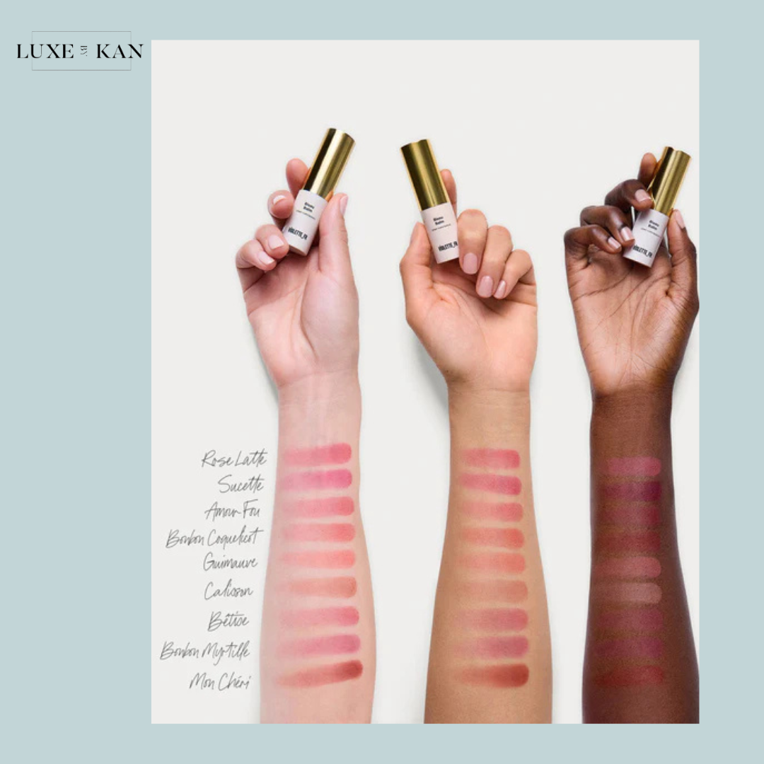 Three arms display lipstick swatches in varying shades, showcasing diverse skin tones, with VIOLETTE FR Bisou Tinted Balm products held above.