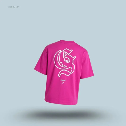 Gymshark Performance T-Shirt in pink shade displayed on a blue background with an oversized boxy-fit short-sleeve design back view