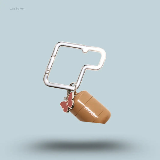 Rhode Carabiner Charm Clip holding Pocket Pearl as a charm on a bag