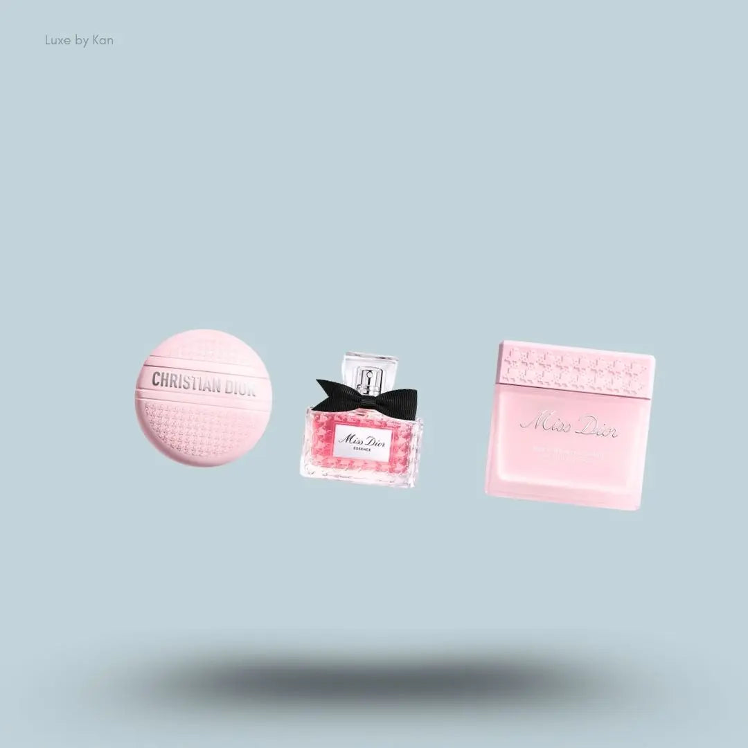 Dior Miss Dior Rose Ritual Trio set with Essence de Parfum, hand cream and body cream, flat lay on light blue background