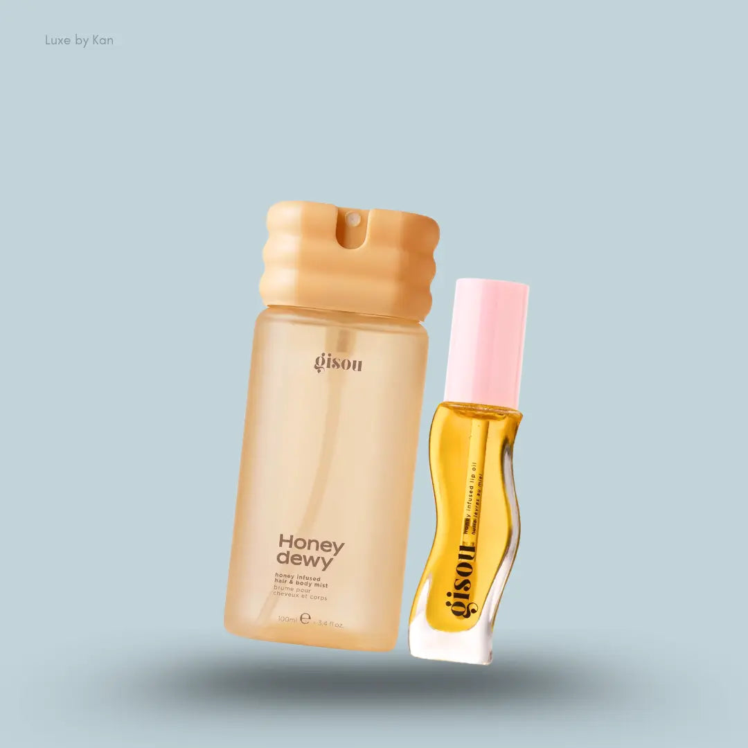 Gisou Honey Glow Spritz & Swipe Duo with Honey Dewy mist and Honey Gold lip oil on a blue background