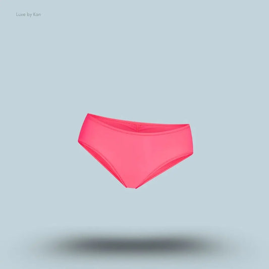 SKIMS Fits Everybody Micro Hipster in Ultra Pink, flat lay on light blue background