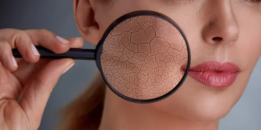 A hand holds a black facial treatment tool against skin, showcasing a textured, Dry Skin, emphasizing skincare routines.