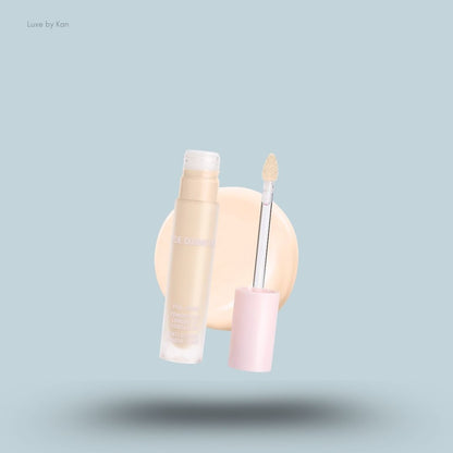 Kylie Cosmetics Power Plush Longwear Concealer bottle and swatch on blue background — LBK India