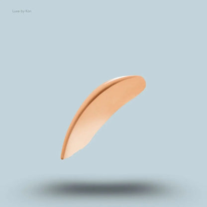 Armani luminous silk multi-purpose glow concealer swatch on blue background.
