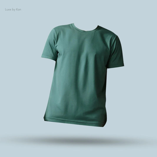 Alo Conquer Reform Crewneck Short Sleeve in green, flat lay on light blue background