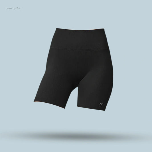 Alo 5 inch Seamless Ribbed Favorite Short in black, flat lay on light blue background