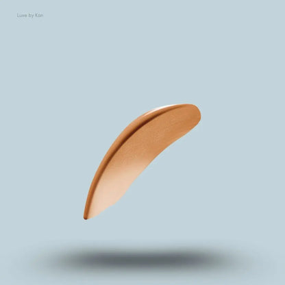 Armani luminous silk multi-purpose glow concealer swatch on blue background.