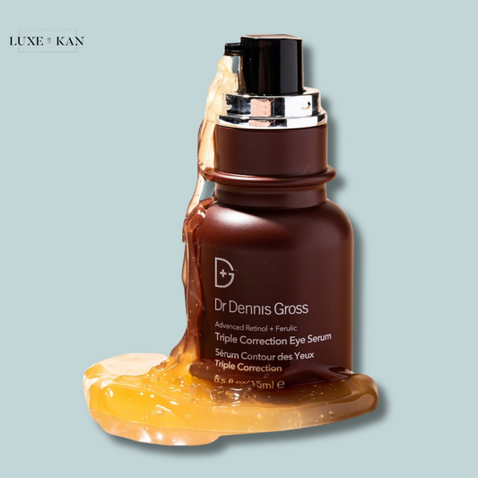 Close-up of Dr. Dennis Gross Triple Correction Eye Serum bottle with golden serum oozing from the top.