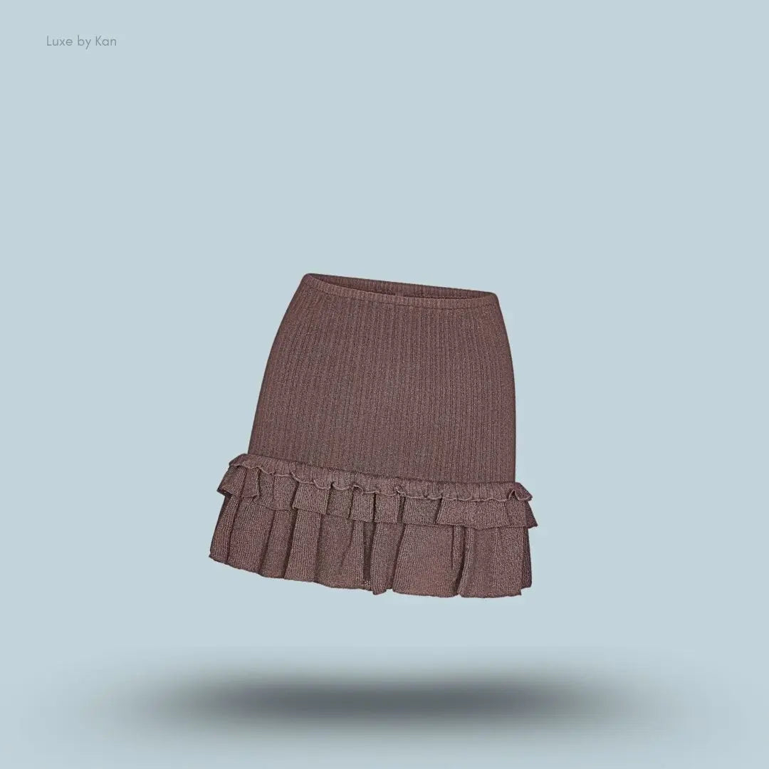 SKIMS Sheer Knit Ruffle Mini Skirt in Amethyst, flat lay on light blue background