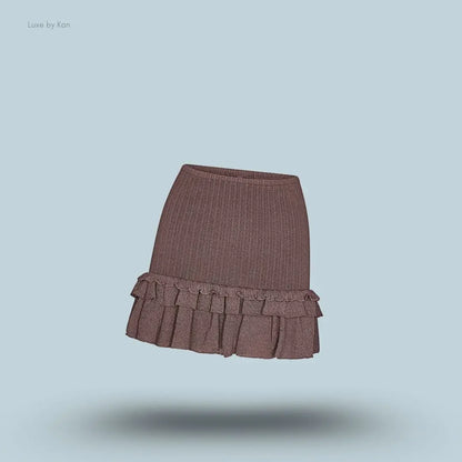 SKIMS Sheer Knit Ruffle Mini Skirt in Amethyst, flat lay on light blue background