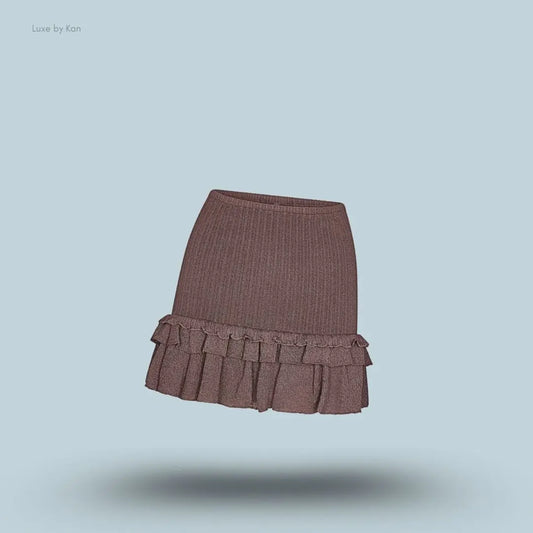 SKIMS Sheer Knit Ruffle Mini Skirt in Amethyst, flat lay on light blue background