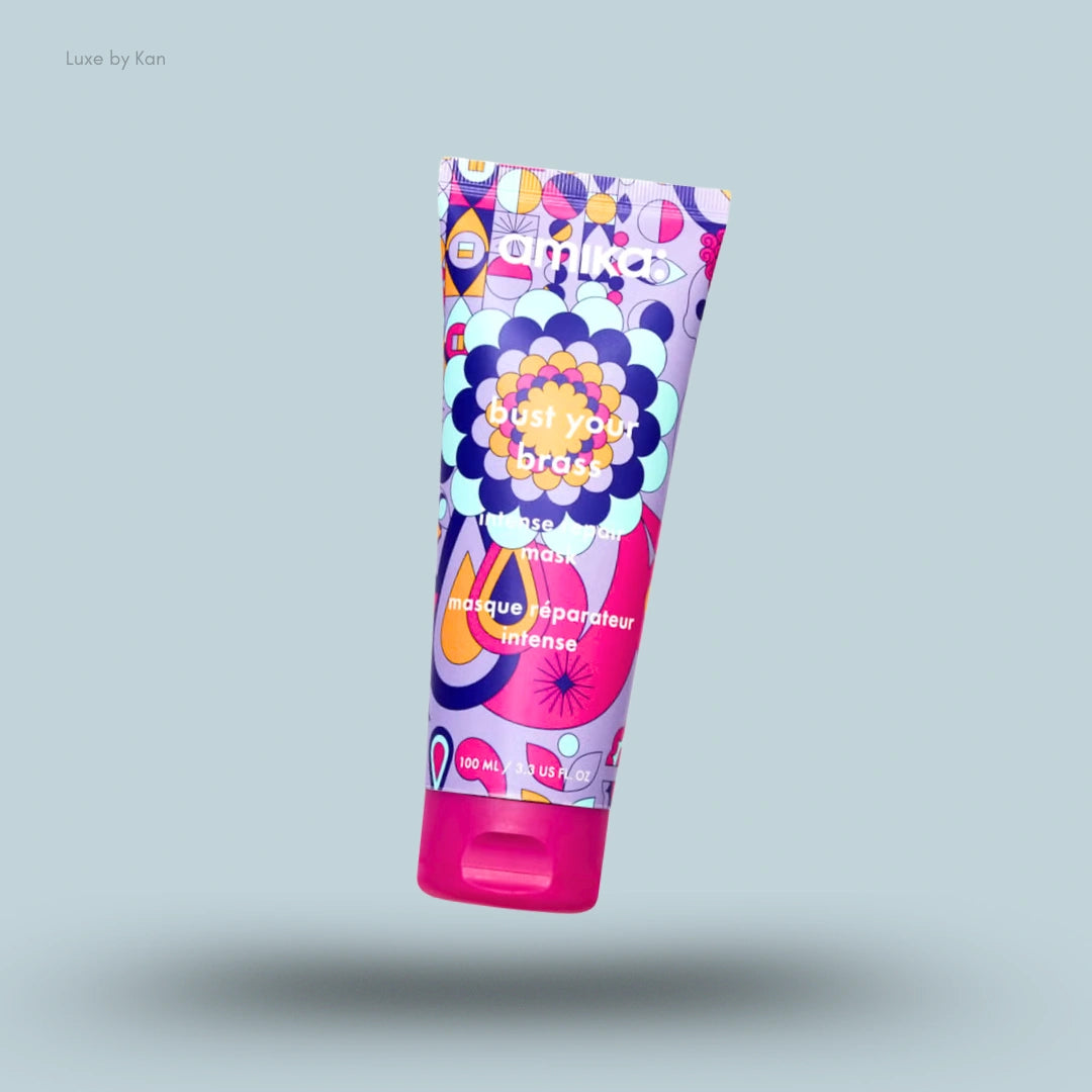 Amika Bust Your Brass Intense Repair Hair Mask tube on blue background — LBK India