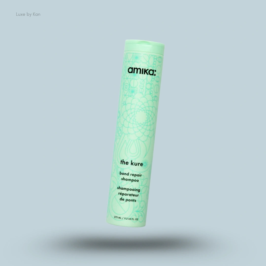 Amika The Kure Bond Repair Shampoo 275ml bottle on blue background — LBK India