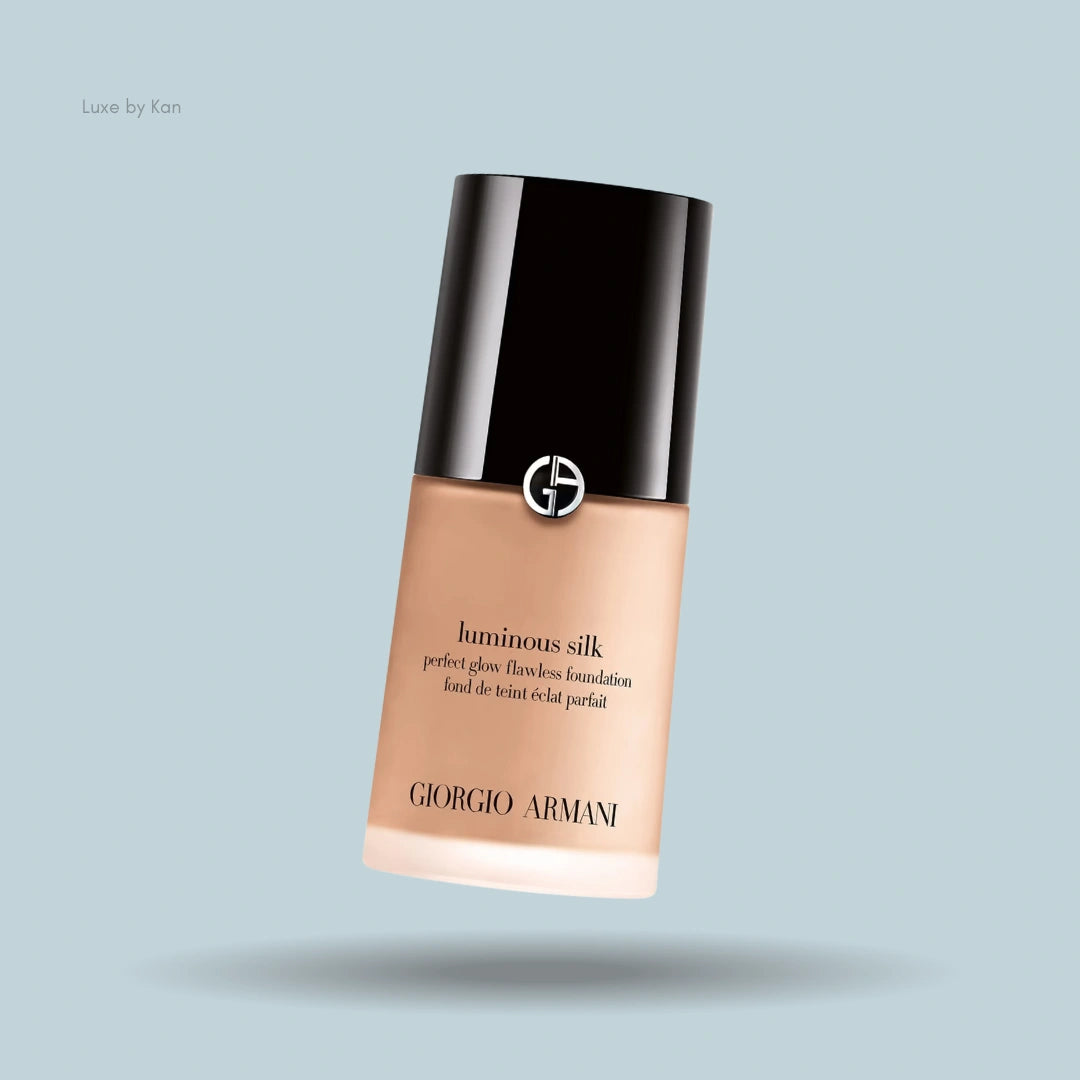 Close-up of Giorgio Armani Luminous Silk foundation bottle against a blue background.