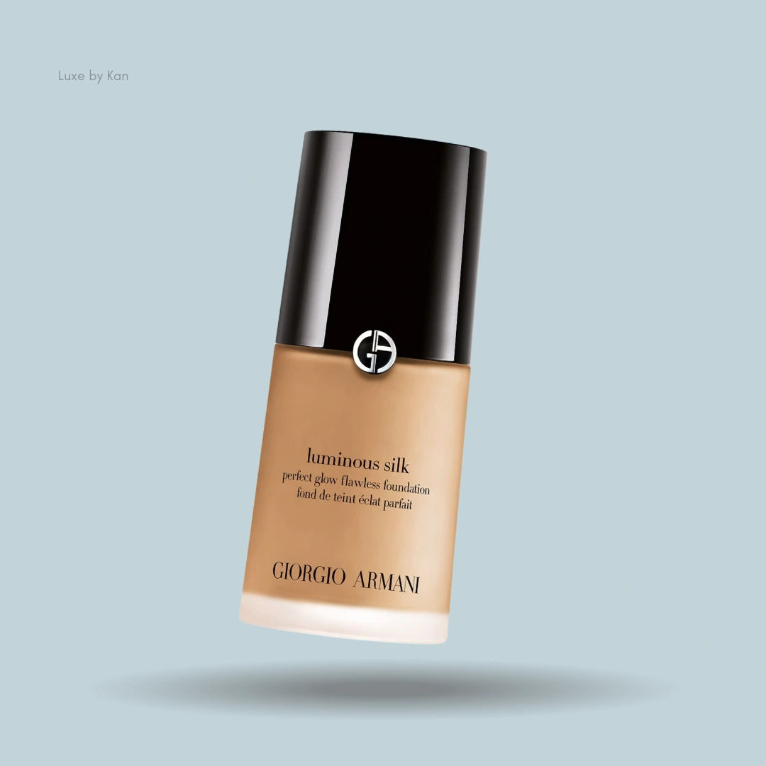 Giorgio Armani Luminous Silk foundation against a light blue background, showcasing its elegant design and branding.