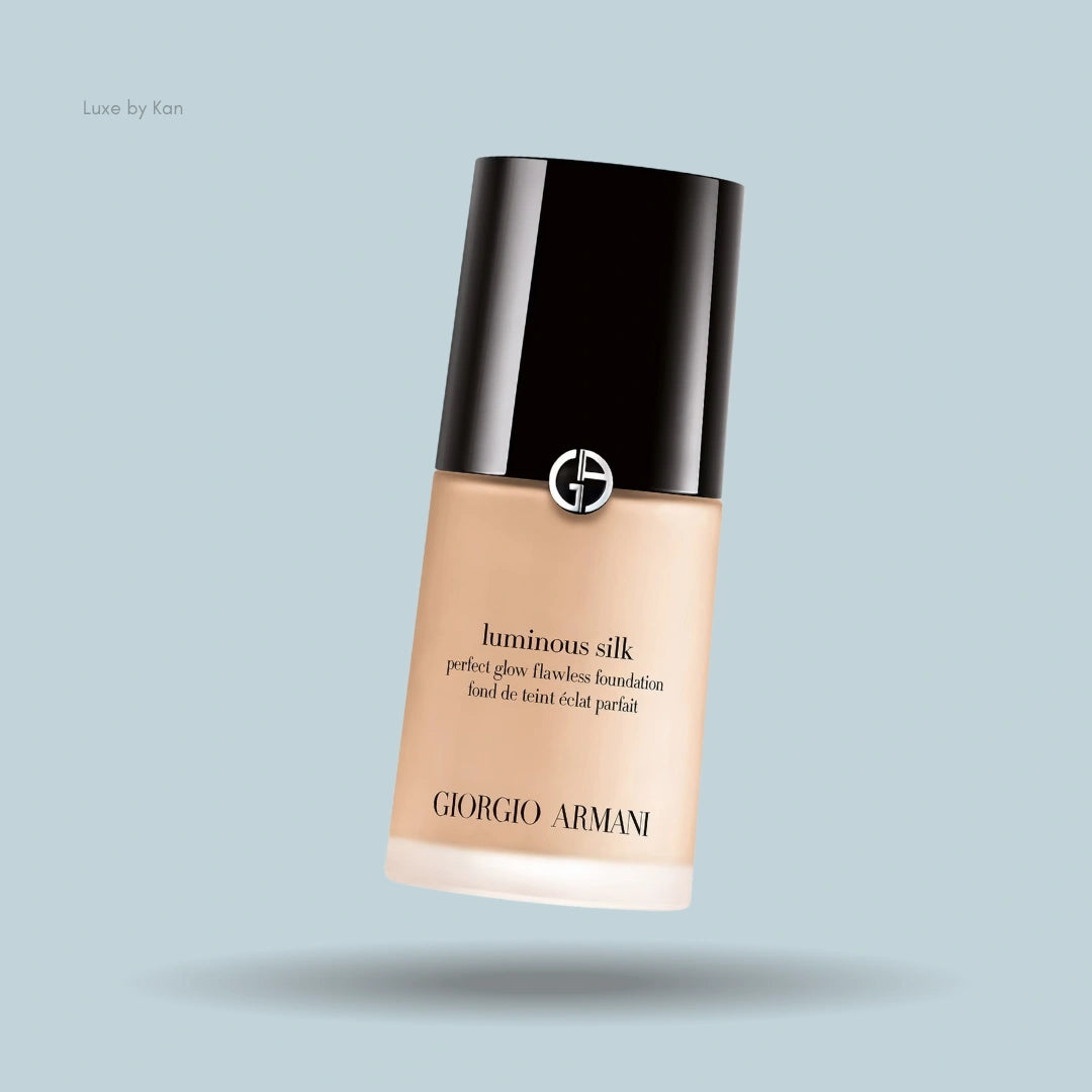 Giorgio Armani Luminous Silk foundation bottle on blue background.
