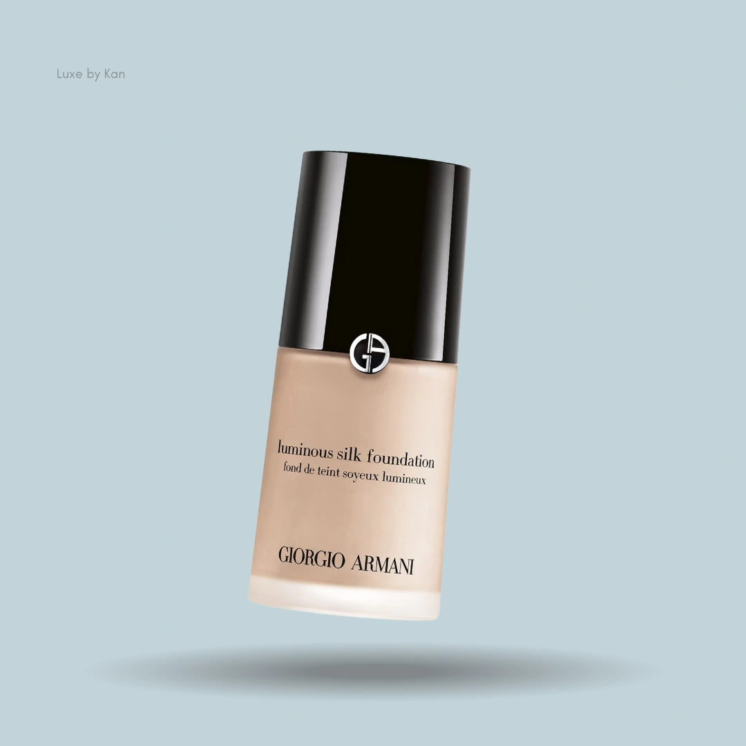 Armani Luminous Silk Foundation bottle angled on light blue background.