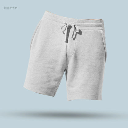 Alo Chill Short in Athletic Heather Grey, flat lay on light blue background