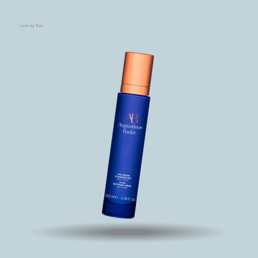 Augustinus Bader cream cleansing gel in a blue container with a bronze-colored pump.