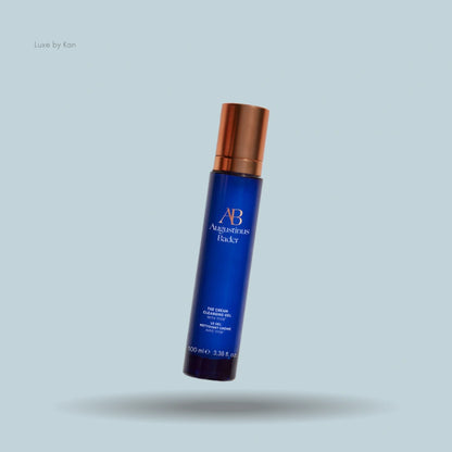 Augustinus Bader's 'The Cream Cleansing Gel' product in a tall blue and copper pump bottle.