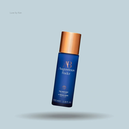 Augustinus Bader blue face mist bottle with gold cap.