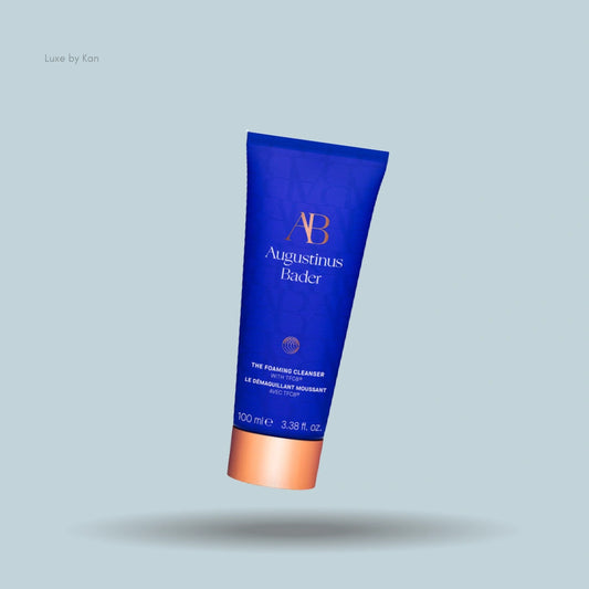 Blue Augustinus Bader foaming cleanser tube with copper colored cap.